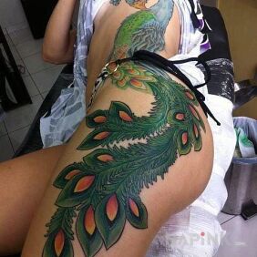 Tattoo Peacock on the ribs motif: colorful