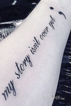 Tattoo To nie koniec historii in lettering motif on the forearm