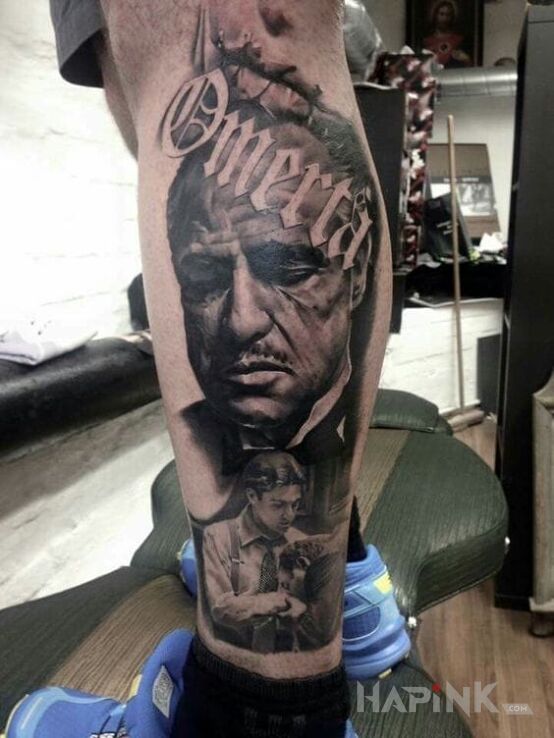 Tattoo Omerta in faces motif and realistic style on the calf