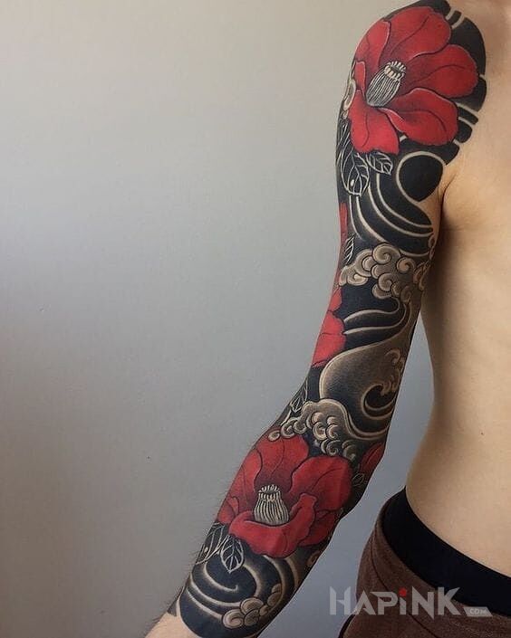 Tattoo Czerwone kwiaty in flowers motif and japanese / irezumi style on the forearm