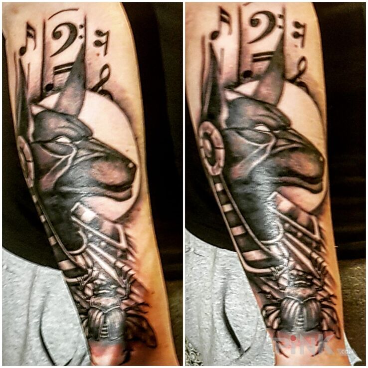 Tattoo ANNUBIS in religious motif on the forearm