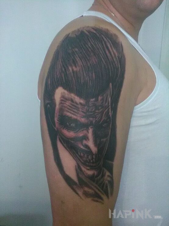 Tattoo Joker ? in characters motif on the upper arm