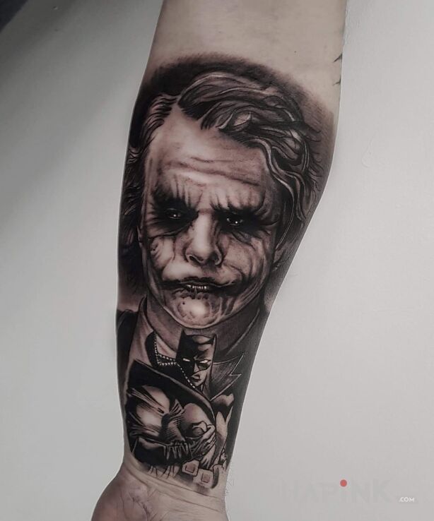 Tattoo Joker in characters motif and realistic style on the forearm