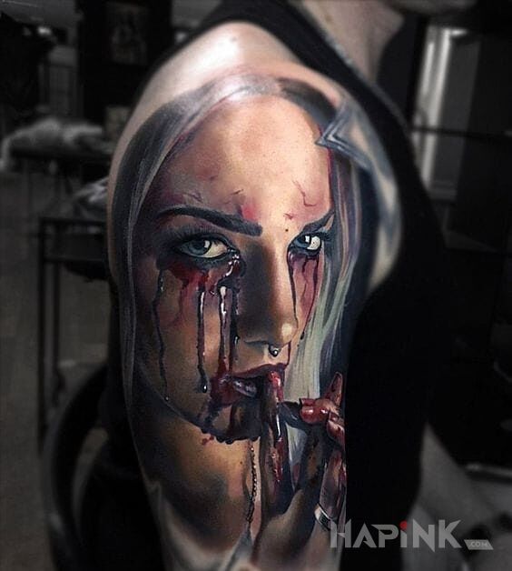 Tattoo Krwawe łzy in colorful motif and realistic style on the upper arm