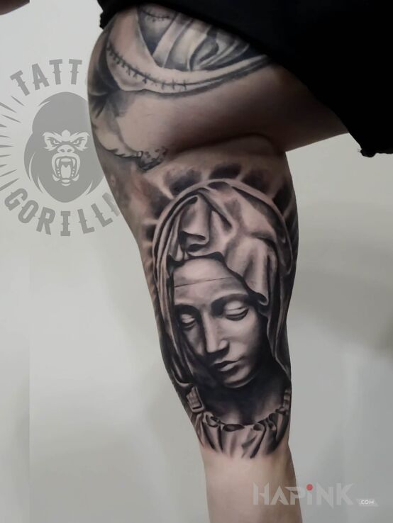 Tattoo Religiny motyw in faces motif and realistic style on the calf