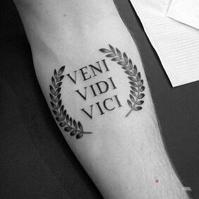 Tattoo VENI VIDI VICI on the forearm motif: lettering