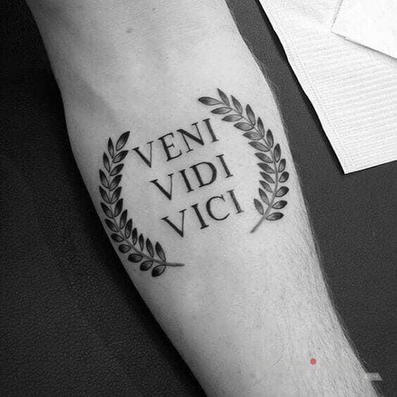 Tattoo VENI VIDI VICI in lettering motif on the forearm