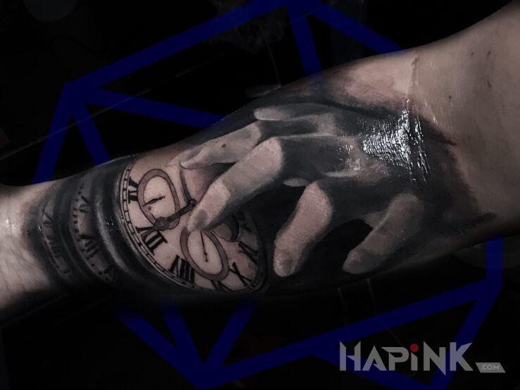 Tattoo Time in objects motif and realistic style on the upper arm