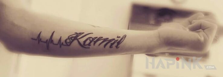Tattoo Imię in lettering motif on the forearm