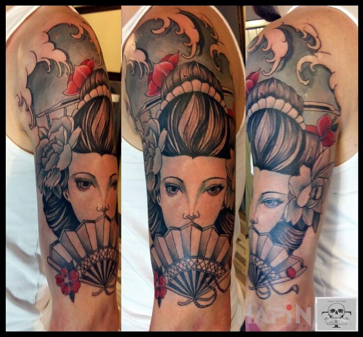 Tattoo Geisha in colorful motif and japanese / irezumi style on the upper arm