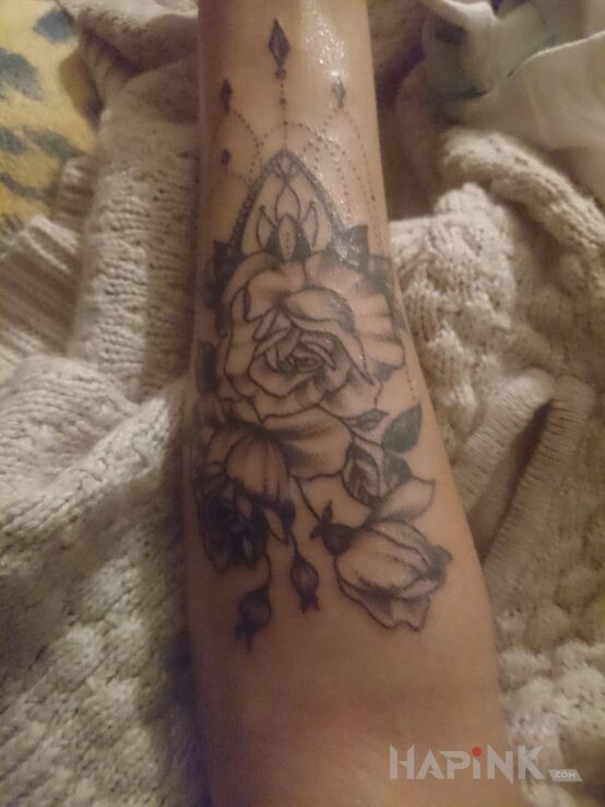 Tattoo Piękny in flowers motif on the forearm