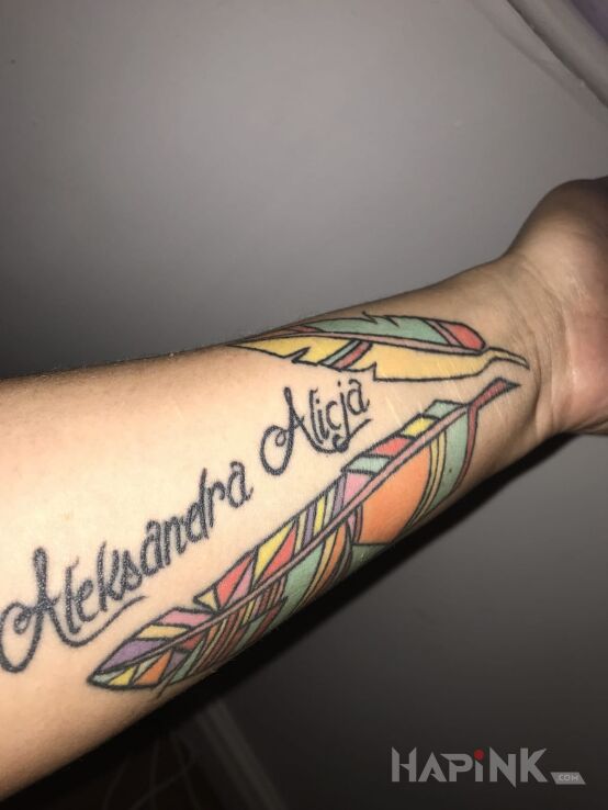 Tattoo Imiona córek in colorful motif on the forearm