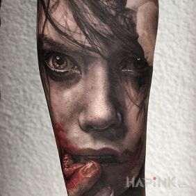 Tattoo Bloodied face on the forearm motif: faces style: realistic