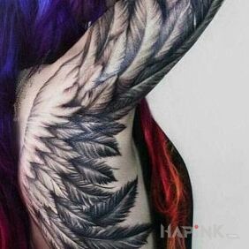 Tattoo Wing on the upper arm style: realistic
