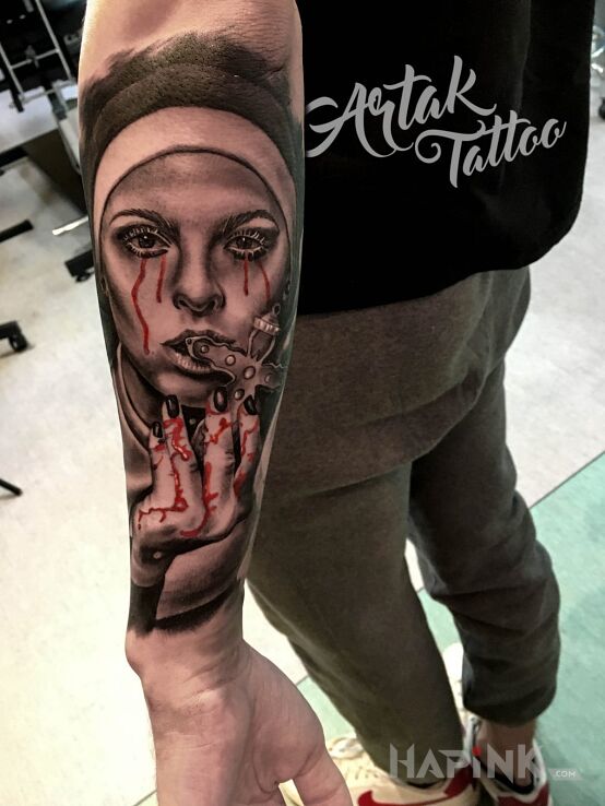 Tattoo Zakonnica in faces motif and realistic style on the forearm