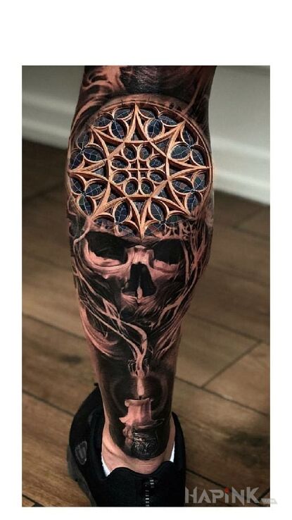 Tattoo Witraz in skulls motif and realistic style on the calf