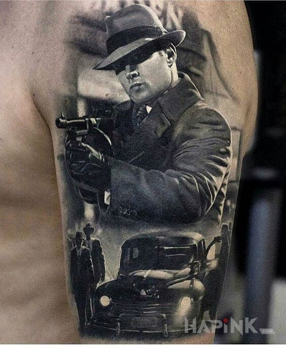 Tattoo Gangsterka in faces motif and realistic style on the upper arm