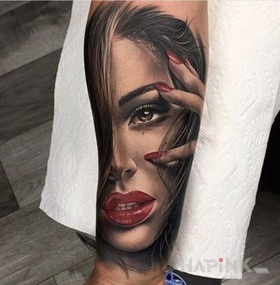Tattoo Czerwone usta in faces motif and realistic style on the forearm