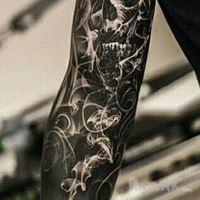 Tattoo Dark Sleeve on the forearm motif: skulls style: realistic