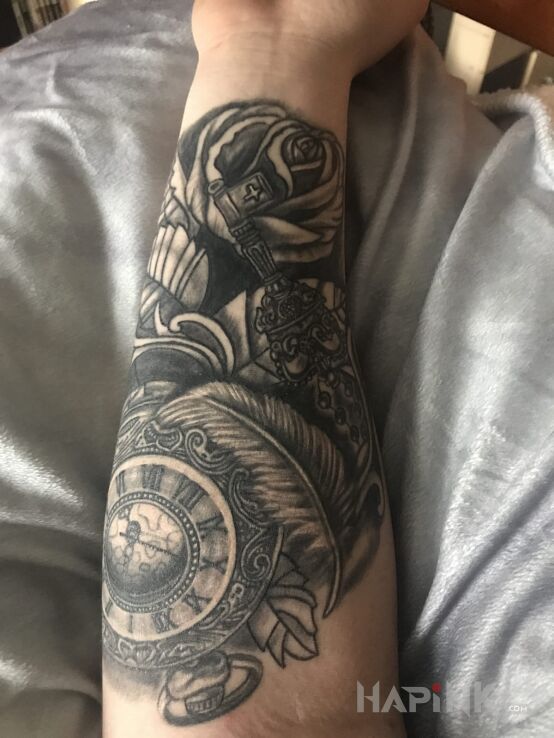 Tattoo Cos in objects motif on the forearm