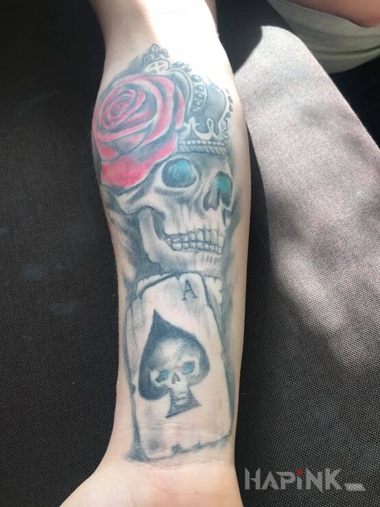 Tattoo As króla in colorful motif on the forearm