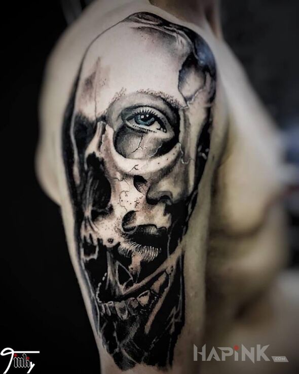 Tattoo Czacha in skulls motif on the upper arm