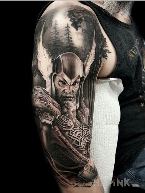 Tattoo Thor in characters motif and realistic style on the upper arm