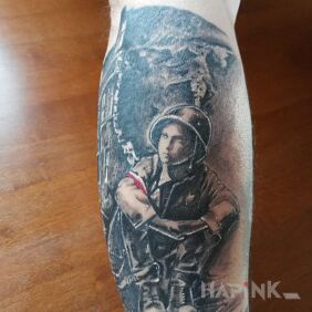 Tattoo A small insurgent in the rubble of Warsaw on the forearm motif: patriotic