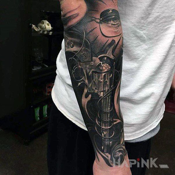 Tattoo Rewolwer in 3D motif and realistic style on the forearm