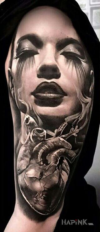 Tattoo Kobiece serce in faces motif and realistic style on the upper arm