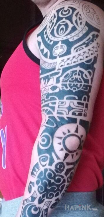 Tattoo Maori in sleeves motif and Polynesian style on the upper arm