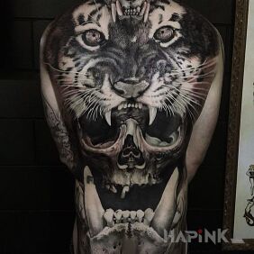 Tattoo Tiger and skulls on the back motif: animals style: realistic