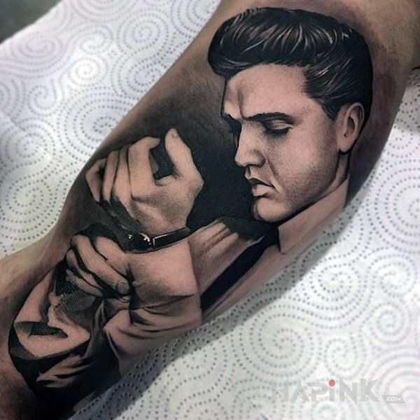 Tattoo Elvis in faces motif and realistic style on the upper arm