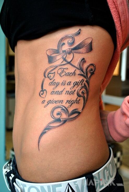 Tattoo Każdy dzień jest darem in lettering motif on the ribs