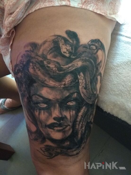 Tattoo Meduza in faces motif on the leg