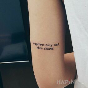 Tattoo Happiness on the upper arm motif: lettering