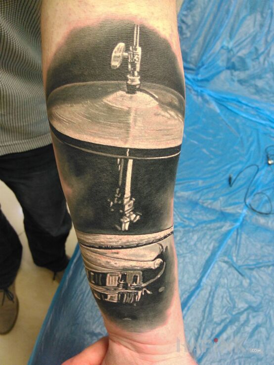 Tattoo Drums tattoo in realistic style on the forearm