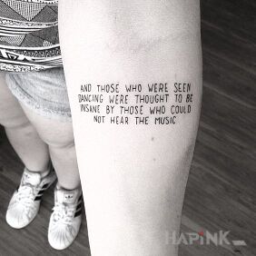 Tattoo About music on the forearm motif: lettering