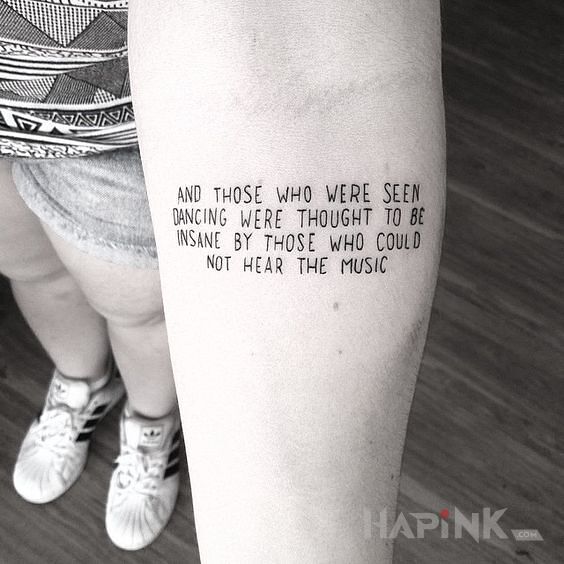 Tattoo O muzyce in lettering motif on the forearm