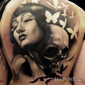 Tattoo The girl with the skull on the back motif: butterflies style: realistic