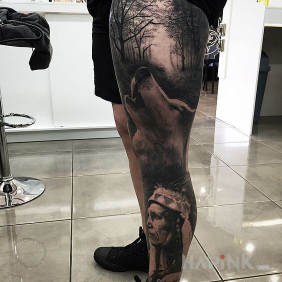 Tattoo Indianin i wilk in faces motif and realistic style on the calf