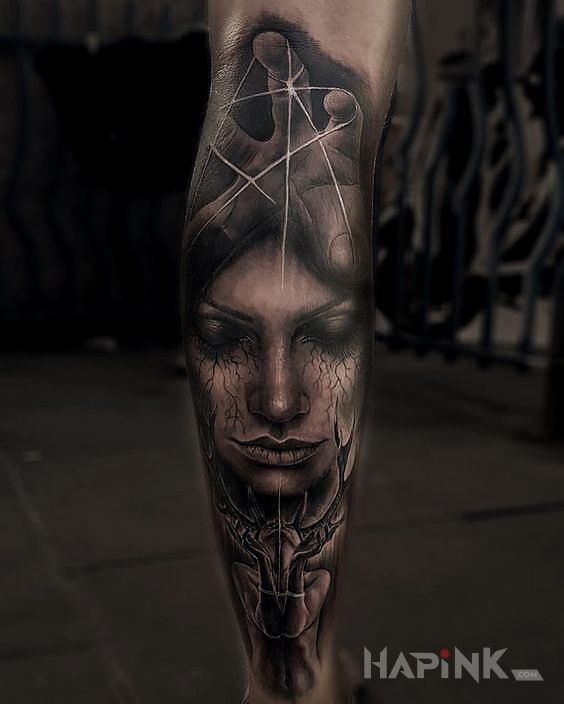 Tattoo Oczy zamknięte in faces motif and realistic style on the calf