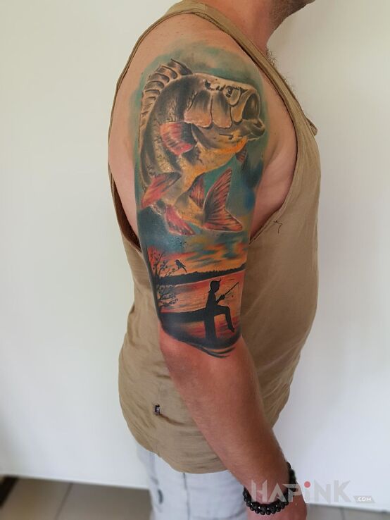 Tattoo Okoń, hobby in animals motif and realistic style on the upper arm