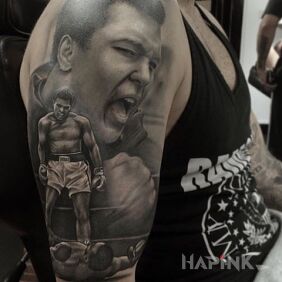 Tattoo Muhammad Ali on the upper arm motif: characters style: realistic