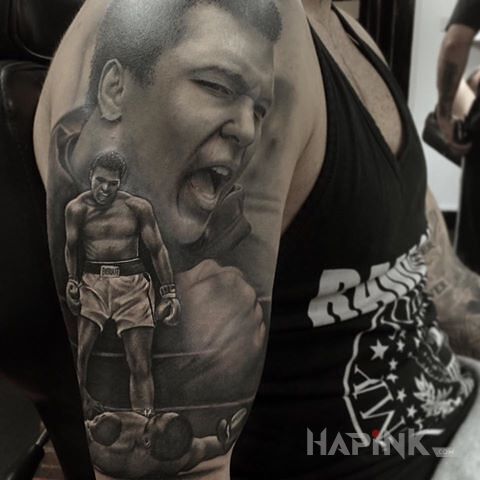 Tattoo Muhammad Ali in faces motif and realistic style on the upper arm