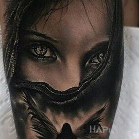 Tattoo The figure of an angel on the upper arm motif: faces style: realistic