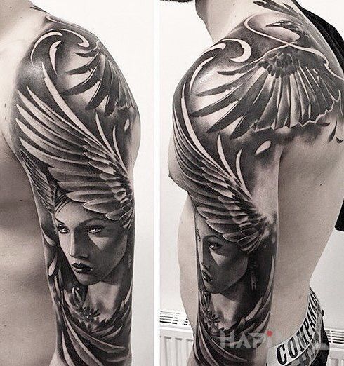 Tattoo Skrzydlata głowa in faces motif and realistic style on the upper arm