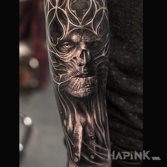 Tattoo Demoniczna postać in faces motif and realistic style on the forearm