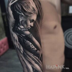Tattoo An angel with holes on the upper arm motif: sexy style: realistic