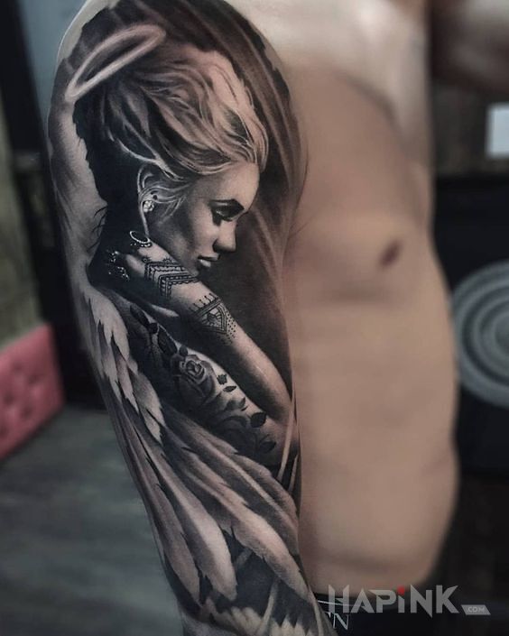 Tattoo Aniol z dziarami in sexy motif and realistic style on the upper arm